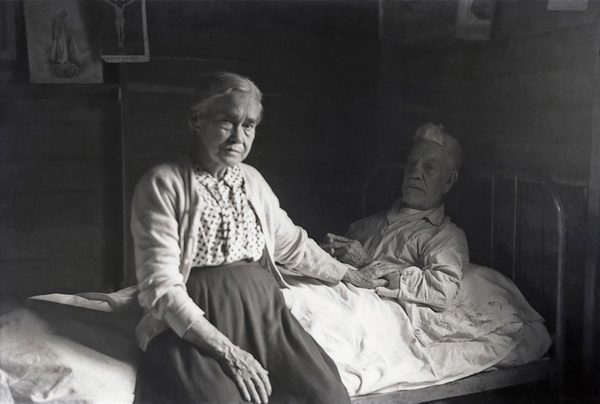 Beside Her Ailing Husband
